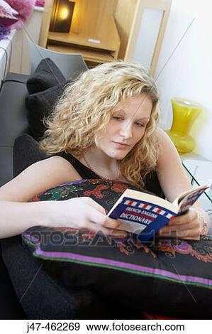 20 year old girl sitting on the sofa, reading a book View Large Photo Image Stock Photo - 20 year old girl sitting on the sofa, reading a book. Fotosearch
