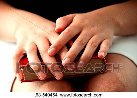 20 yr old woman holding book on her lap View Large Photo Image Picture - 20 yr old woman holding book on her lap. Fotosearch
