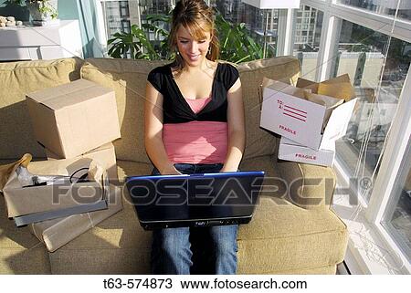 20 yr old woman home shopping on a laptop computer View Large Photo Image Stock Image - 20 yr old woman home shopping on a laptop computer. Fotosearch