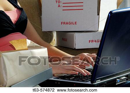 20 yr old woman home shopping on laptop computer with parcels around her on sofa View Large Photo Image Stock Image - 20 yr old woman home shopping on laptop computer with parcels around her on sofa. Fotosearch