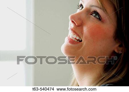 20 yr old woman looking up and laughing View Large Photo Image Picture - 20 yr old woman looking up and laughing. Fotosearch