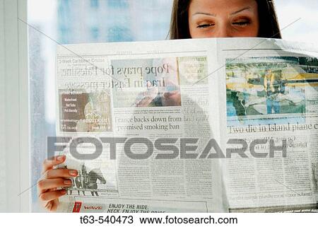20 yr old woman reading newspaper at home View Large Photo Image Stock Image - 20 yr old woman reading newspaper at home. Fotosearch