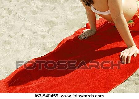 20 yr old woman relaxing on red towel at the beach View Large Photo Image Stock Photo - 20 yr old woman relaxing on red towel at the beach. Fotosearch