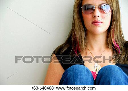 20 yr old woman sitting and leaning against a wall View Large Photo Image Stock Photo - 20 yr old woman sitting and leaning against a wall. Fotosearch