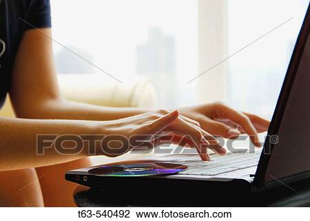 20 yr old woman typing on laptop computer at home View Large Photo Image Stock Image - 20 yr old woman typing on laptop computer at home. Fotosearch