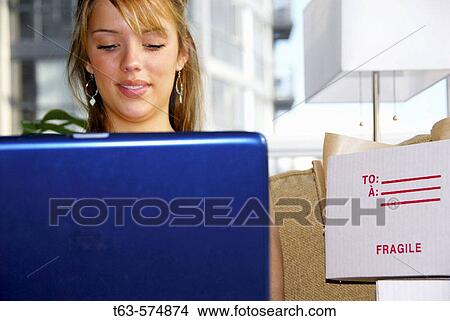20 yr old woman using laptop computer to home shop View Large Photo Image Picture - 20 yr old woman using laptop computer to home shop. Fotosearch