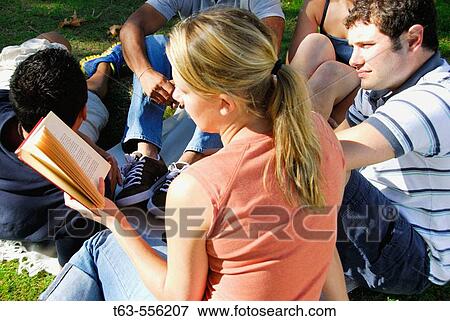 20 yr old woman/girl reading to group of ethnic friends View Large Photo Image Stock Photo - 20 yr old woman/girl reading to group of ethnic friends. Fotosearch