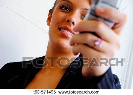 Stock Photography - 20 yr old young woman holding cell phone. Fotosearch