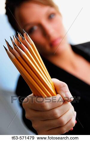 20 yr old young woman holding handful of pencils View Large Photo Image Stock Photo - 20 yr old young woman holding handful of pencils. Fotosearch