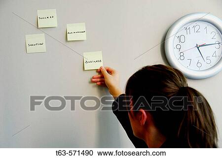 20 yr old young woman holding sticky business note View Large Photo Image Stock Image - 20 yr old young woman holding sticky business note. Fotosearch