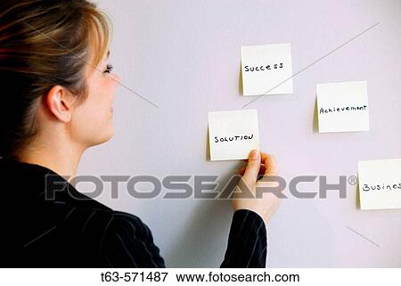 20 yr old young woman looking at sticky notes on wall View Large Photo Image Stock Photo - 20 yr old young woman looking at sticky notes on wall. Fotosearch
