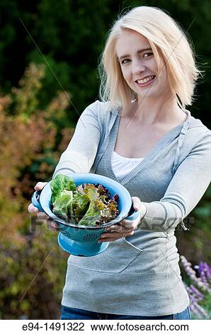 21 year old blond woman holding a bowl of freshly harvested lettuce in a garden. View Large Photo Image Stock Image - 21 year old blond woman holding a bowl of freshly harvested lettuce in a garden.. Fotosearch