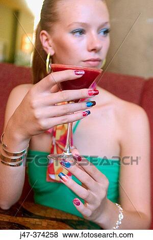 21 year old, blonde girl in restaurant, holding a cocktail View Large Photo Image Stock Photo - 21 year old, blonde girl in restaurant, holding a cocktail. Fotosearch