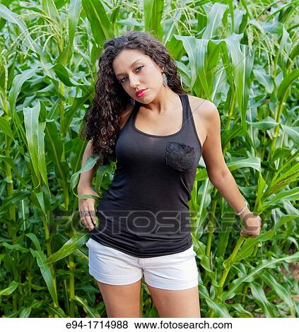 21 year old brunette woman standing by corn plants View Large Photo Image Stock Photo - 21 year old brunette woman standing by corn plants. Fotosearch