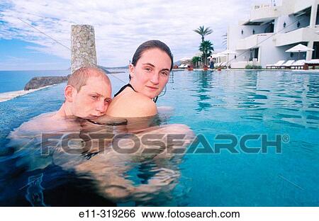 21 year old couple in swimming pool View Large Photo Image Stock Photograph - 21 year old couple in swimming pool. Fotosearch