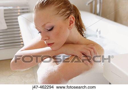 21 year old girl in the bath, leaning on the side, looking down View Large Photo Image Picture - 21 year old girl in the bath, leaning on the side, looking down. Fotosearch