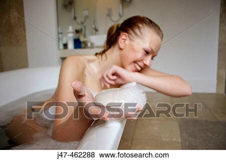 21 year old girl in the bath, leaning on the side, smiling holding a bar of soap out to the camera View Large Photo Image Stock Photo - 21 year old girl in the bath, leaning on the side, smiling holding a bar of soap out to the camera. Fotosearch