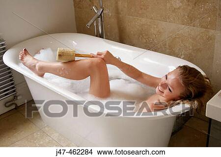 21 year old girl in the bath, using a loofah on her legs View Large Photo Image Picture - 21 year old girl in the bath, using a loofah on her legs. Fotosearch