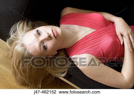 21 year old girl lying on sofa facing up, looking into camera View Large Photo Image Stock Image - 21 year old girl lying on sofa facing up, looking into camera. Fotosearch