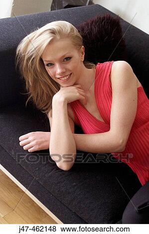 21 year old girl lying on sofa smiling into camera View Large Photo Image Stock Photo - 21 year old girl lying on sofa smiling into camera. Fotosearch