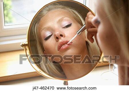 21 year old girl sitting doing her makeup in the mirror View Large Photo Image Stock Image - 21 year old girl sitting doing her makeup in the mirror. Fotosearch