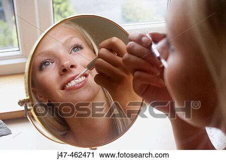21 year old girl sitting doing her makeup in the mirror View Large Photo Image Stock Image - 21 year old girl sitting doing her makeup in the mirror. Fotosearch