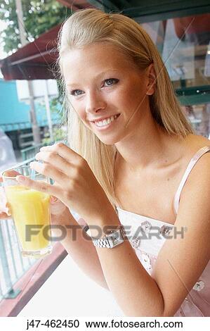 21 year old girl sitting in a cafe drinking orange View Large Photo Image Stock Image - 21 year old girl sitting in a cafe drinking orange. Fotosearch