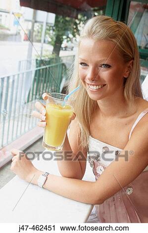 21 year old girl sitting in a cafe drinking orange View Large Photo Image Stock Image - 21 year old girl sitting in a cafe drinking orange. Fotosearch