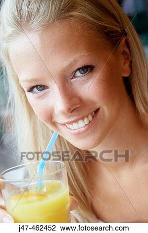 21 year old girl sitting in a cafe drinking orange juice View Large Photo Image Stock Image - 21 year old girl sitting in a cafe drinking orange juice. Fotosearch