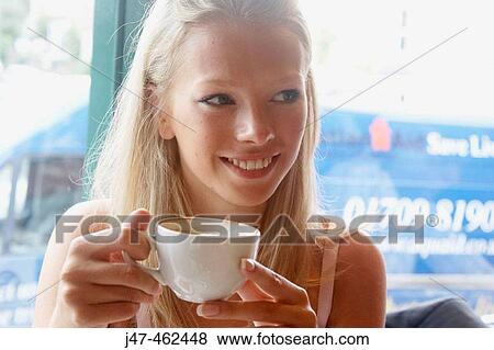 21 year old girl sitting in a cafe drinking coffee View Large Photo Image Stock Photo - 21 year old girl sitting in a cafe drinking coffee. Fotosearch
