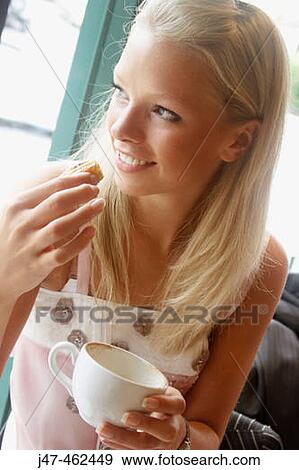 21 year old girl sitting in a cafe drinking coffee View Large Photo Image Stock Photo - 21 year old girl sitting in a cafe drinking coffee. Fotosearch