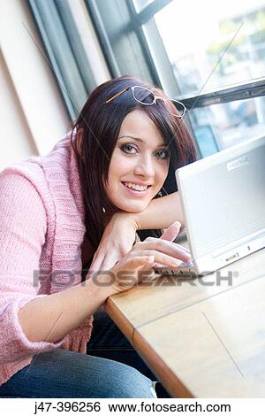 21 year old girl, sitting in bar, with a mini DVD player, smiling at camera View Large Photo Image Stock Photograph - 21 year old girl, sitting in bar, with a mini DVD player, smiling at camera. Fotosearch
