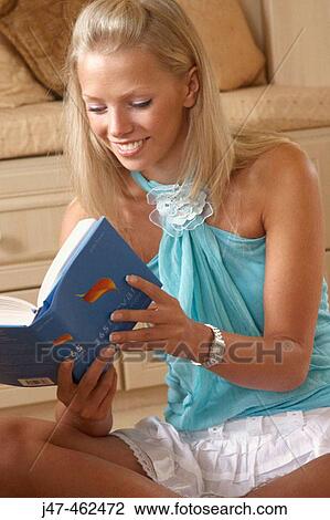 21 year old girl sitting in the bedroom reading a book smiling View Large Photo Image Stock Image - 21 year old girl sitting in the bedroom reading a book smiling. Fotosearch