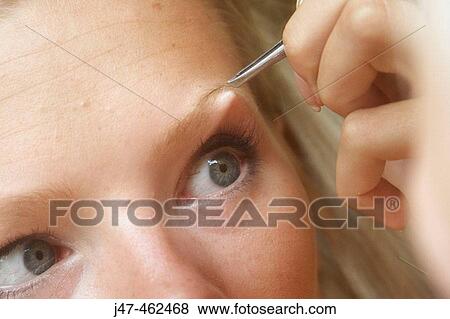 21 year old girl sitting plucking her eyebrows in the mirror View Large Photo Image Stock Photo - 21 year old girl sitting plucking her eyebrows in the mirror. Fotosearch