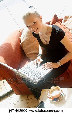 21 year old girl working on a laptop on her knee View Large Photo Image Stock Image - 21 year old girl working on a laptop on her knee. Fotosearch