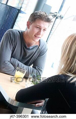 21 year old man, head and shoulders, smiling at a girl sitting across the table from him View Large Photo Image Stock Image - 21 year old man, head and shoulders, smiling at a girl sitting across the table from him. Fotosearch