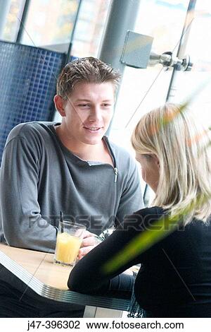 21 year old man, head and shoulders, smiling at a girl sitting across the table from him View Large Photo Image Stock Image - 21 year old man, head and shoulders, smiling at a girl sitting across the table from him. Fotosearch