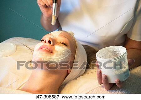 21 year old woman having a face mask applyed by a beauty therapist View Large Photo Image Stock Photo - 21 year old woman having a face mask applyed by a beauty therapist. Fotosearch