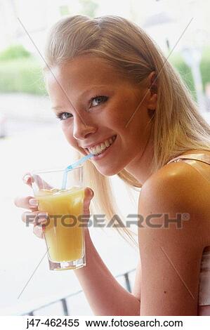 21 year oldgirl sitting in a cafe drinking orange juice View Large Photo Image Stock Photography - 21 year oldgirl sitting in a cafe drinking orange juice. Fotosearch