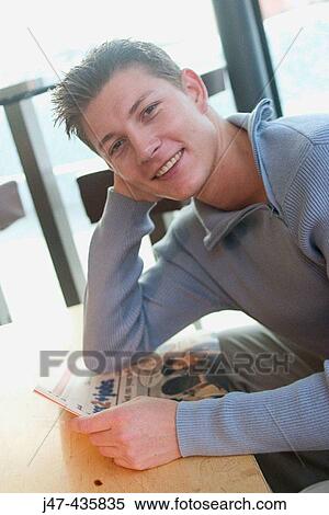 22 year old boy sitting with the newspaper smiling into camera View Large Photo Image Stock Photography - 22 year old boy sitting with the newspaper smiling into camera. Fotosearch