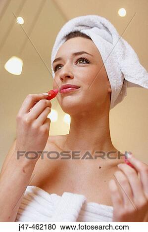 22 year old girl wrapped in a towel holding a lipgloss smiling off camera View Large Photo Image Stock Image - 22 year old girl wrapped in a towel holding a lipgloss smiling off camera. Fotosearch