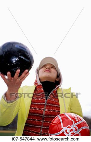 22 year old latin woman throwing soccer balls View Large Photo Image Picture - 22 year old latin woman throwing soccer balls. Fotosearch