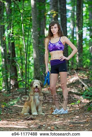 23 year old brunette woman dressed in exercise clothing walking her dog through a forest View Large Photo Image Stock Photo - 23 year old brunette woman dressed in exercise clothing walking her dog through a forest. Fotosearch