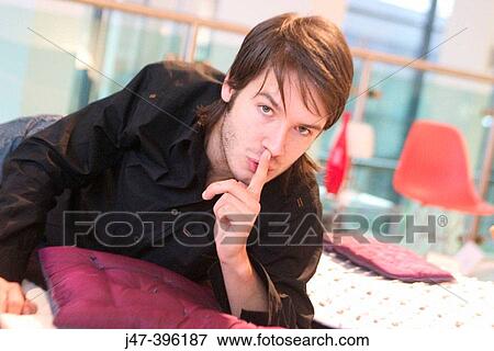 24 year old man lying on bed, finger up to mouth, saying ssshhh View Large Photo Image Stock Photo - 24 year old man lying on bed, finger up to mouth, saying ssshhh. Fotosearch