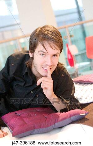 24 year old man lying on bed, finger up to mouth, saying ssshhh View Large Photo Image Stock Photo - 24 year old man lying on bed, finger up to mouth, saying ssshhh. Fotosearch