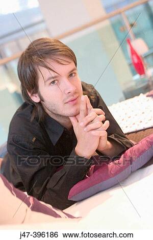 24 year old man lying on bed, hands up to mouth, looking into camera View Large Photo Image Stock Photograph - 24 year old man lying on bed, hands up to mouth, looking into camera. Fotosearch