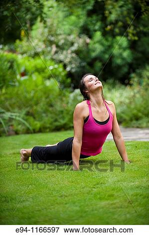 25 year old brunette woman in a garden settng wearing work out clothing, stretching and exercising View Large Photo Image Stock Photo - 25 year old brunette woman in a garden settng wearing work out clothing, stretching and exercising. Fotosearch