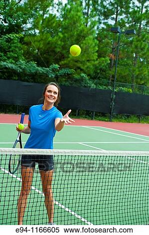 25 year old brunette woman on a tennis court playing with racquet and ball View Large Photo Image Stock Photography - 25 year old brunette woman on a tennis court playing with racquet and ball. Fotosearch
