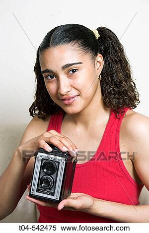 25-year-old Dominican woman holding antique camera. View Large Photo Image Stock Photography - 25-year-old Dominican woman holding antique camera.. Fotosearch
