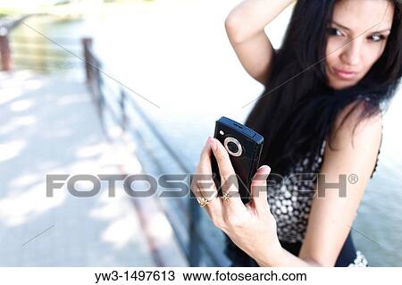 25 year old pretty woman outdoors taking photo of herself View Large Photo Image Stock Image - 25 year old pretty woman outdoors taking photo of herself. Fotosearch
